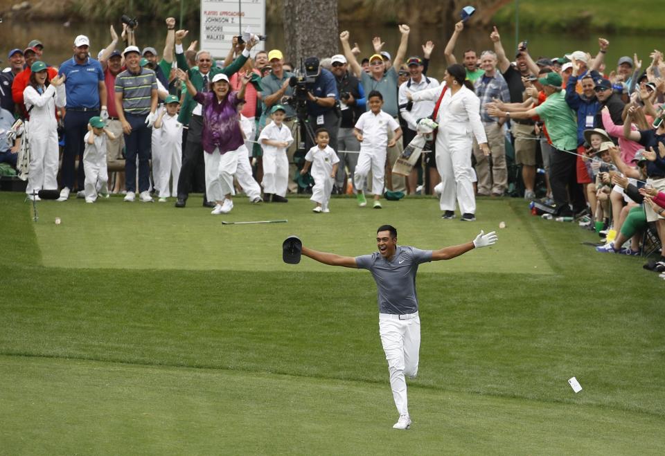 Tony Finau reacts after hitting a hole in one on the seventh home during the par three competition at the Masters golf tournament Wednesday. (AP)