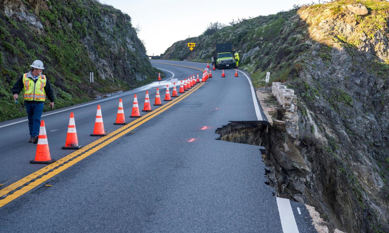 <span>An engineer assesses a break in the southbound lane of Highway 1 at Rocky Creek Bridge in Big Sur, California, on 1 April 2024 following an Easter weekend storm.</span><span>Photograph: Nic Coury/AP</span>