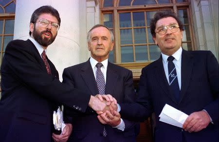 Sinn Fein leader Gerry Adams (L), Irish Prime Minister Albert Reynolds (C) and SDLP leader John Hume join hands following their meeting at Government Buildings in Dublin in this file photograph dated September 6, 1994. REUTERS/Kevin Lamarque/files