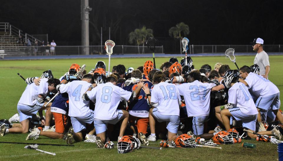 Benjamin players are joined in prayer by players from St. John Paul II after Benjamin's Jayden Vega is injured during a game against St. John Paul II on Mar. 8, 2024.