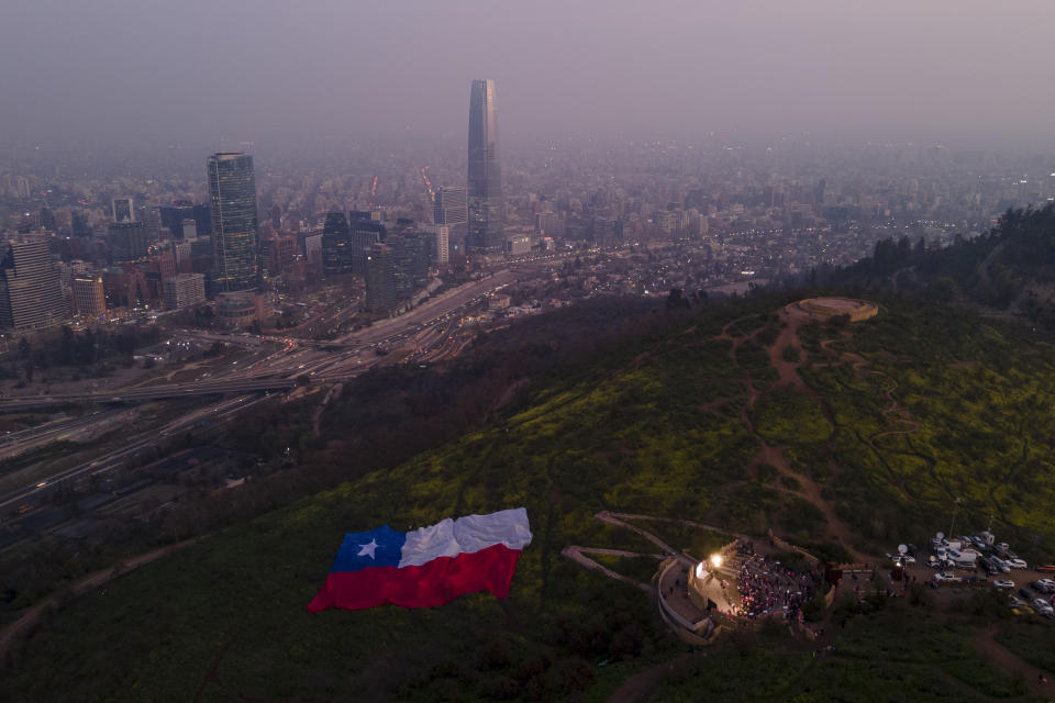 Demonstrators rally at the Pablo Neruda amphitheater against the proposed new Constitution in Santiago, Chile, Thursday, Sept. 1, 2022. Chileans have until the Sept. 4 plebiscite to study the new draft and decide if it will replace the current Magna Carta imposed by a military dictatorship 41 years ago. (AP Photo/Matias Basualdo)