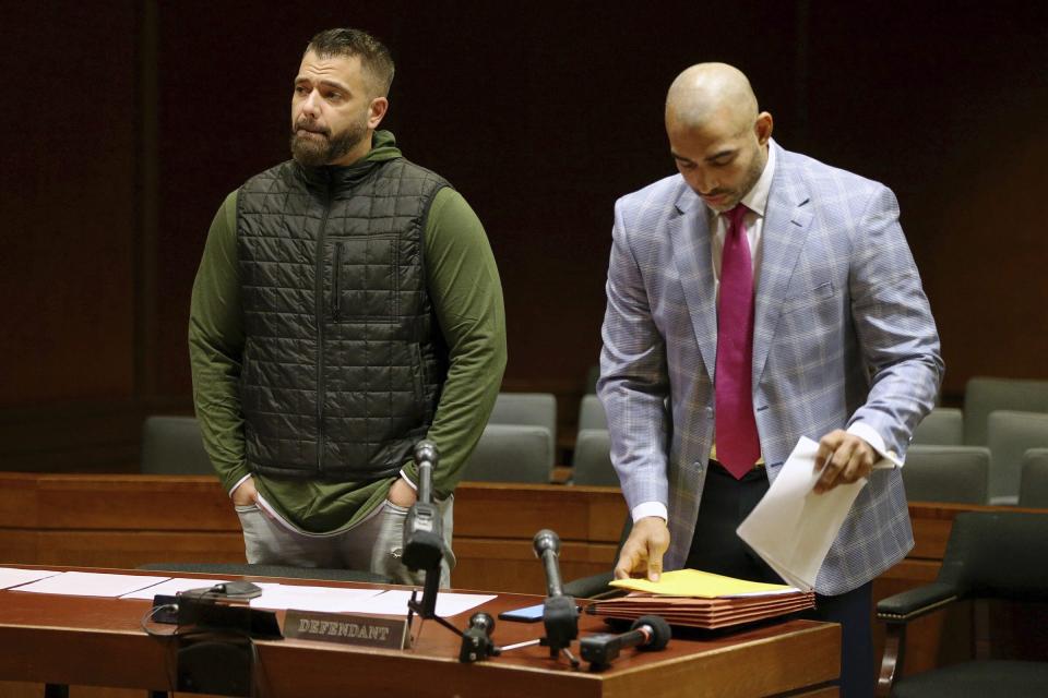 Mark D'Amico, left, stands with his lawyer, Mark Davis, as he prepares to plead guilty to one count of misappropriating entrusted funds in Burlington County Superior Court in Mount Holly, N.J., on Friday, Dec. 6, 2019. Along with his then-girlfriend, Kate McClure, and a homeless man, Johnny Bobbitt, D'Amico allegedly set up a false online fundraiser and kept the money for themselves. (Tim Tai/The Philadelphia Inquirer via AP)