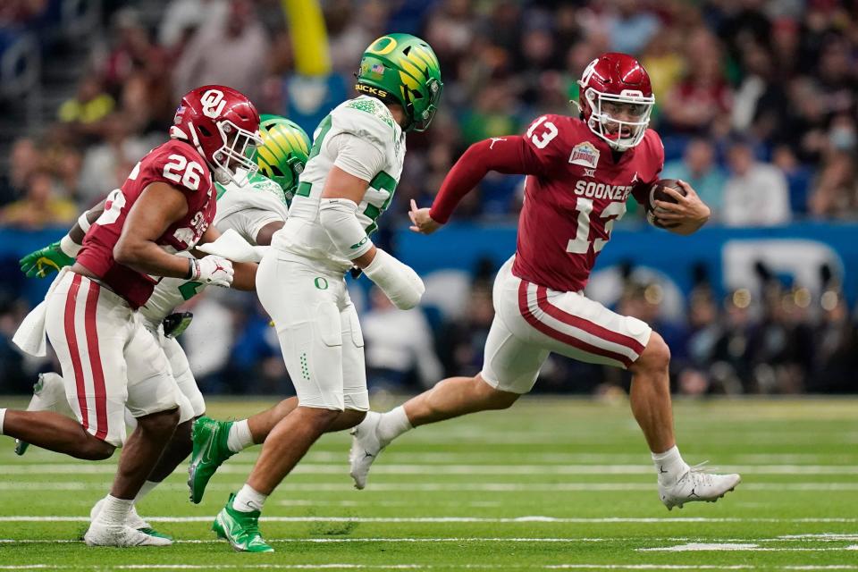 OU quarterback Caleb Williams (13) scramble for yardage against Oregon during the first half of the Alamo Bowl on Wednesday in San Antonio.