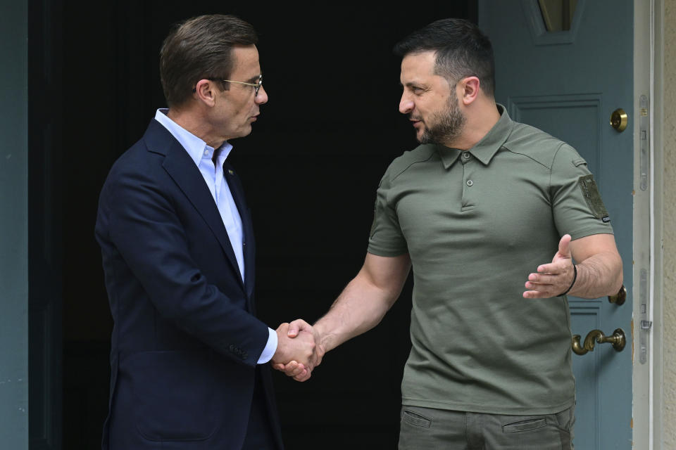 Ukrainian President Volodymyr Zelenskyy, right, shakes hands with Sweden Prime Minister Ulf Kristersson, during his visit to the Prime Minister country retreat, in Harpsund, Sweden, Saturday, Aug. 19, 2023. Zelenskyy is visiting Sweden for the first time since the full-scale Russian invasion of his country. (Jonas Ekstromer/TT News Agency via AP)