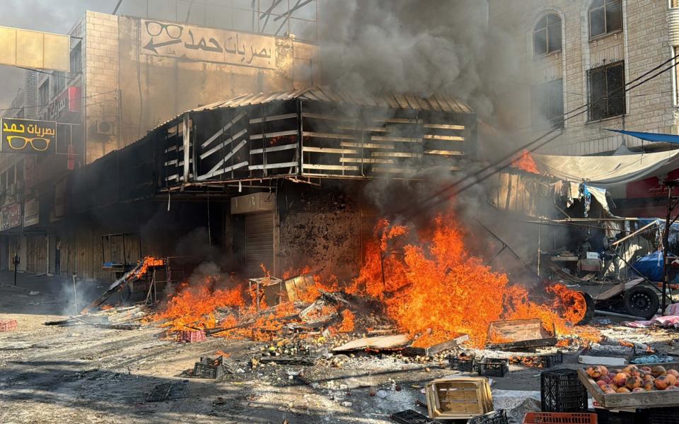 Israeli forces set a vegetable market on fire as the military offensive continues in Jenin