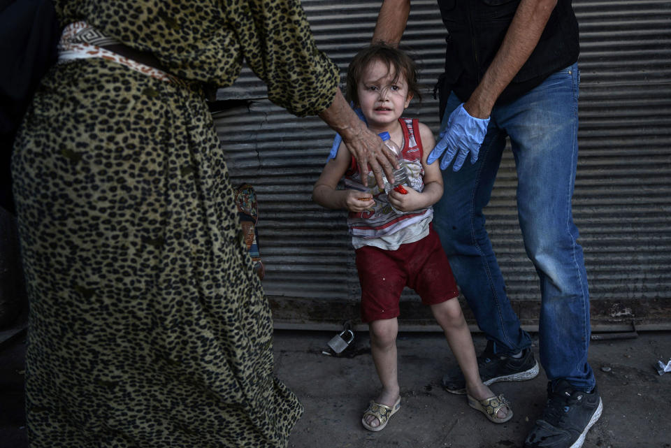 An Iraqi paramedic calms a child