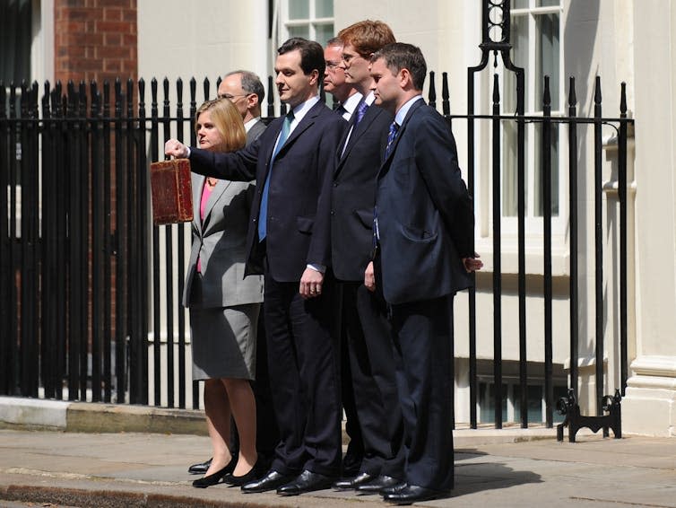 Politicians on a pavement.