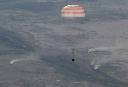 A Soyuz space capsule carrying Russian cosmonaut Anton Shkaplerov, US astronaut Scott Tingle and Japanese astronaut Norishige Kanai lands safely in Kazakhstan