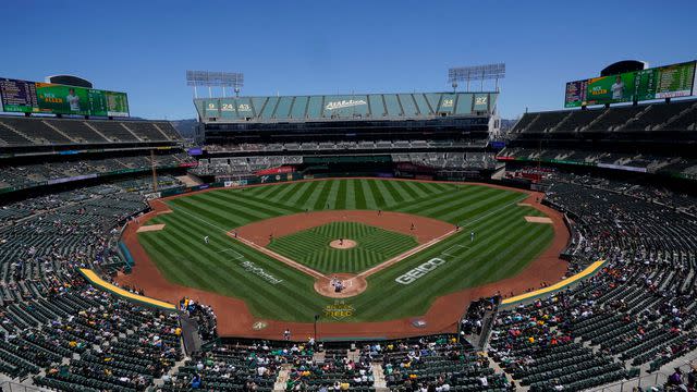 <p>Jeff Chiu/AP Photo</p> Fans at RingCentral Coliseum watch a baseball game between the Oakland Athletics and the Houston Astros in Oakland, California on July 9, 2022