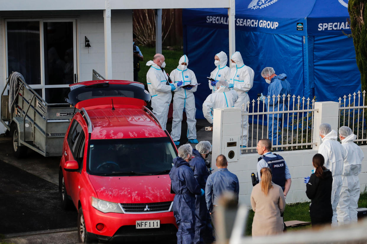 New Zealand police investigators work at a scene in Auckland after bodies were discovered in suitcases. (Dean Purcell/New Zealand Herald via AP)