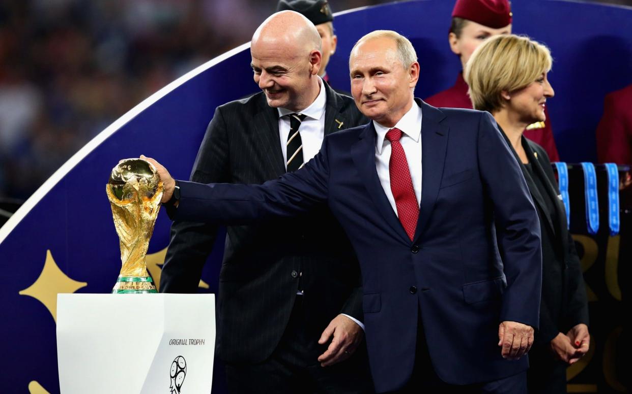 Vladimir Putin touches the World Cup trophy after the 2018 FIFA World Cup Russia Final between France and Croatia at Luzhniki Stadium - Getty Images Europe
