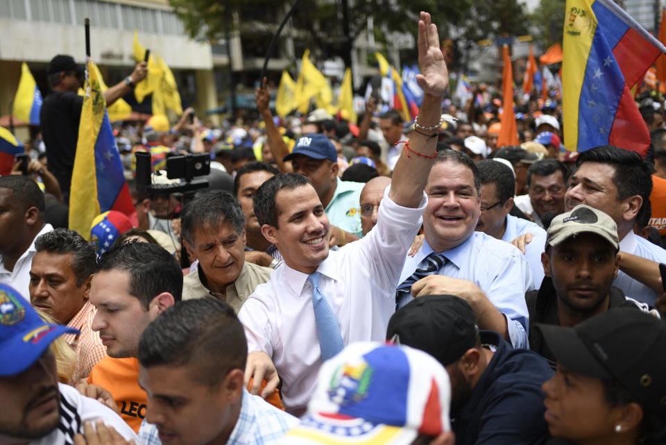 Opposition political leader Juan Guaido is surrounded by supporters during a march in Caracas, Venezuela, Tuesday, March 10, 2020. Guaido called for the march aimed at retaking the National Assembly legislative building, which opposition lawmakers have been blocked from entering. (AP Photo/Matias Delacroix)