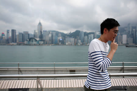 Chan Ho-tin, 26, founder of the pro-independence Hong Kong National Party, participates in an interview in front of Victoria Harbour and the Hong Kong Island skyline in Hong Kong, China, May 5, 2016. REUTERS/Bobby Yip
