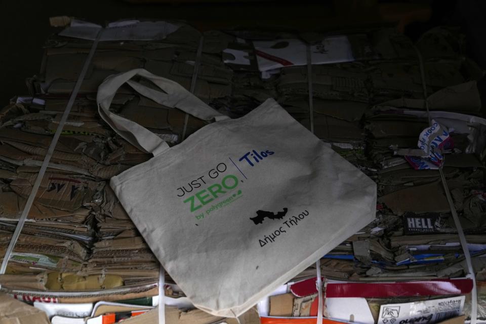 A bag is placed at a recycling plant built on old landfill site on the Aegean Sea island of Tilos, southeastern Greece, Monday, May 9, 2022. When deciding where to test green tech, Greek policymakers picked the remotest point on the map, tiny Tilos. Providing electricity and basic services, and even access by ferry is all a challenge for this island of just 500 year-round inhabitants. It's latest mission: Dealing with plastic. (AP Photo/Thanassis Stavrakis)