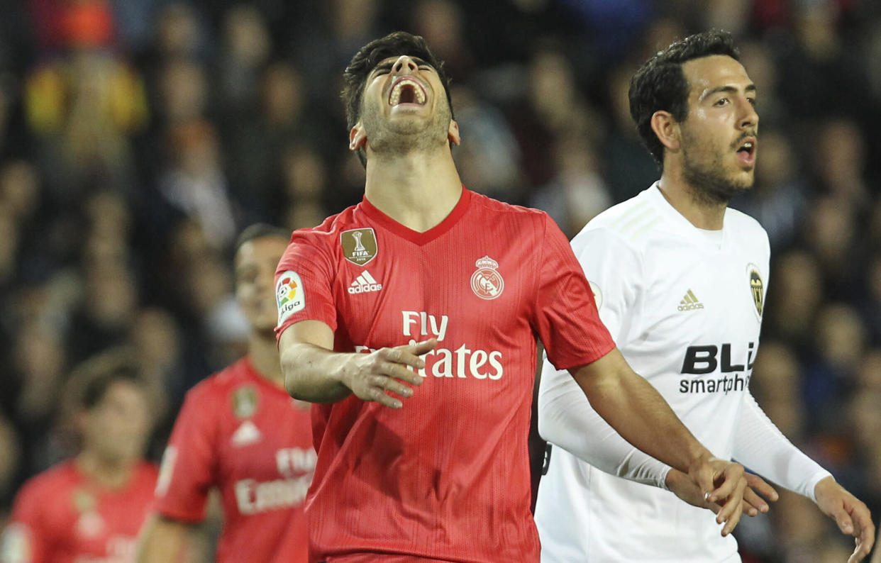 Real Madrid's midfielder Marco Asensio reacts during the Spanish La Liga soccer match between Valencia and Real Madrid at the Mestalla Stadium in Valencia, Spain, Wednesday, April 3, 2019. (AP Photo/Alberto Saiz)