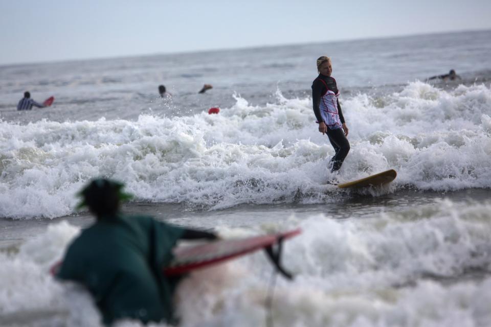 A participant surfs during the third annual Rockaway Halloween surf competition at Rockaway Beach in the Queens borough of New York