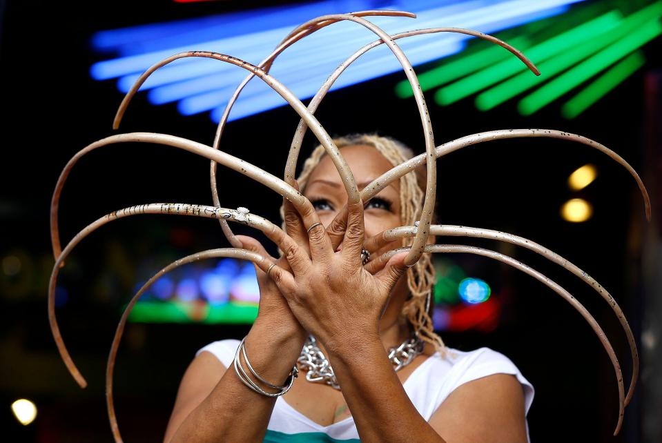 Ayanna Williams displays her 23-inch nails at a book launch in London. Williams is featured in a book entitled "Ripley's Believe it or Not! 2015 Annual, Reality Shock."