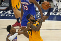 New York Knicks guard RJ Barrett, left, defends as Utah Jazz forward Royce O'Neale, right, lays the ball up in the second half during an NBA basketball game Tuesday, Jan. 26, 2021, in Salt Lake City. (AP Photo/Rick Bowmer)