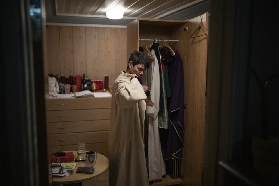 The Rev. Siv Limstrand prepares for a service at Svalbard Kirke in Longyearbyen, Norway, Tuesday, Jan. 10, 2023. For the lone pastor in this fragile, starkly beautiful environment, the challenge is to fulfill the church's historical mission of ministering to those in crisis while addressing a pressing and divisive contemporary challenge. "We pray every Sunday for everyone who's affected by climate change," Limstrand said. (AP Photo/Daniel Cole)