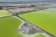 Brine evaporates in pools at the lithium extraction plant facilities of the SQM Lithium company near Peine, Chile, Tuesday, April 18, 2023. In the “lithium triangle” – a region spanning Argentina, Chile and Bolivia – native communities sit upon a treasure trove of the stuff: an estimated trillion dollars in lithium. (AP Photo/Rodrigo Abd)