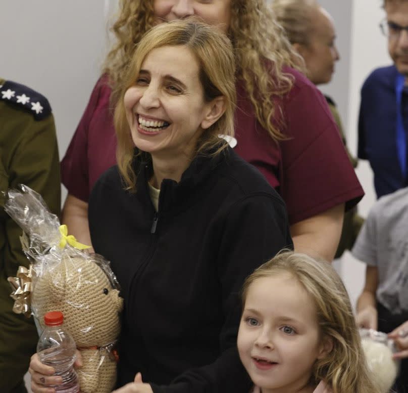 Danielle Aloni laughs next to her daughter Emilia Aloni as they meet family members at the Schneider Children's Medical Center, Israel after their release from captivity