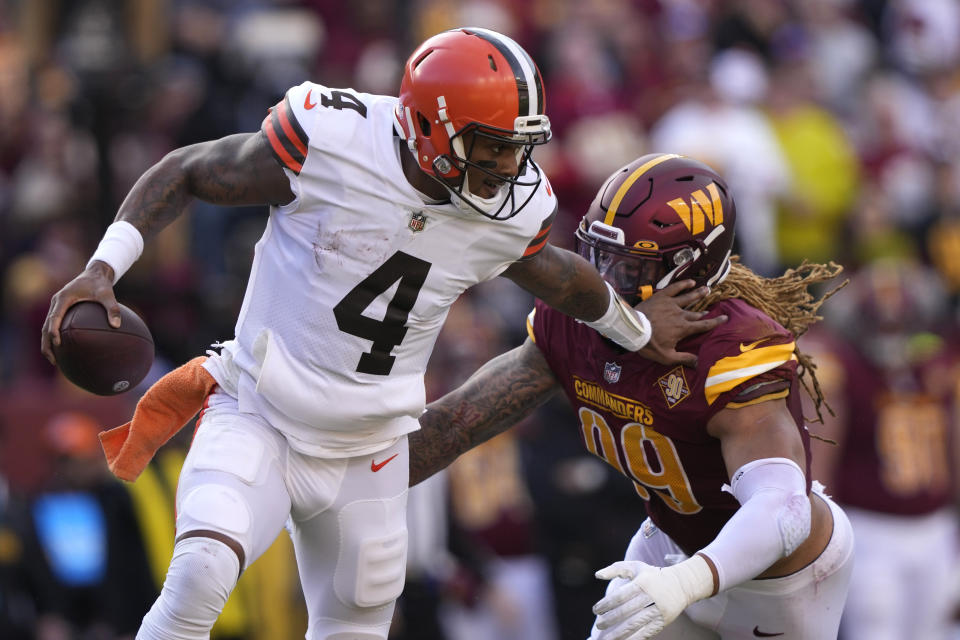 Cleveland Browns quarterback Deshaun Watson (4) gets away from Washington Commanders defensive end Chase Young (99) during the first half of an NFL football game, Sunday, Jan. 1, 2023, in Landover, Md. (AP Photo/Susan Walsh)