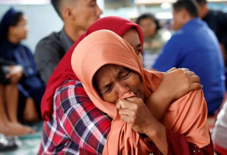 Lela Supiyanti, cries for her daughter, a passenger on the KM Sinar Bangun ferry which sank in Lake Toba, at Tigaras port in Simalungun, North Sumatra, Indonesia. REUTERS/Beawiharta