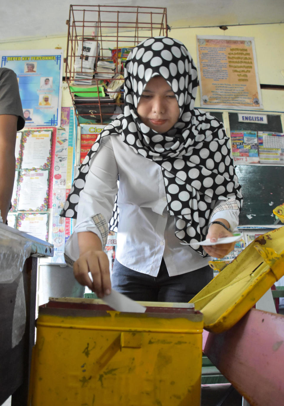 A Muslim woman casts her vote in a referendum in Maguindanao province, southern Philippines, Monday, Jan. 21, 2019. Muslims in the southern Philippines voted Monday in a referendum on a new autonomous region that seeks to end nearly half a century of unrest, in what their leaders are touting as the best alternative to a new wave of Islamic State group-inspired militants. (Kyodo News via AP)
