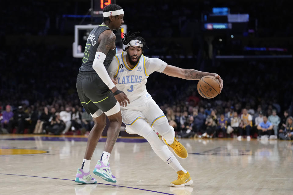 Los Angeles Lakers forward Anthony Davis drives against Minnesota Timberwolves forward Jaden McDaniels during the first half of an NBA basketball game Friday, March 3, 2023, in Los Angeles. (AP Photo/Marcio Jose Sanchez)