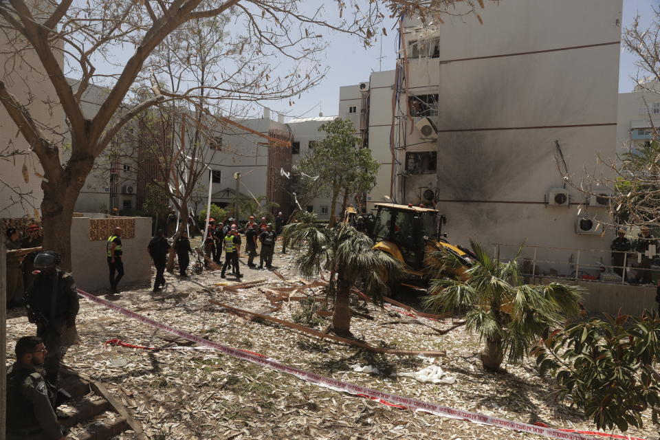 Israeli security forces inspect a residential building after it was hit by a rocket fired from the Gaza Strip, in Ashdod, Israel, Monday, May 17, 2021. (AP Photo/Maya Alleruzzo)