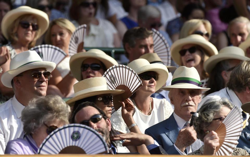 TV personality Bruce Forsyth and wife Wilnelia Merced watch from the royal box on Centre Court at the Wimbledon Tennis Championships in London, July 1, 2015. REUTERS/Toby Melville