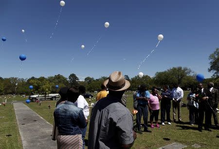 Rodney Scott (C), brother of the late Walter Scott, watches as balloons are released as relatives and friends gathered to remember Scott, at Live Oak Memorial Gardens in Charleston, South Carolina, April 4, 2016. REUTERS/Randal Hill