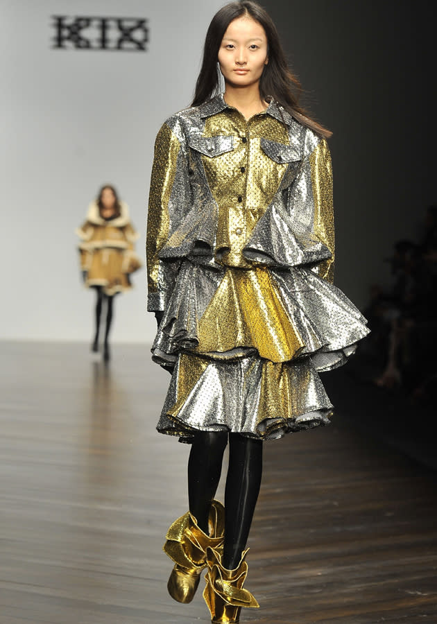 <b><b>London Fashion Week AW13:</b> KTZ<br><br></b>A model hits the KTZ runway showcasing the metallic trend, in this gold and silver creation with two tiered skirting.<br><br>©Rex