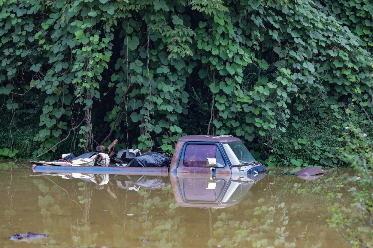 An abandoned pickup truck is seen submerged under floodwaters in Jackson, Ky., on Thursday. 