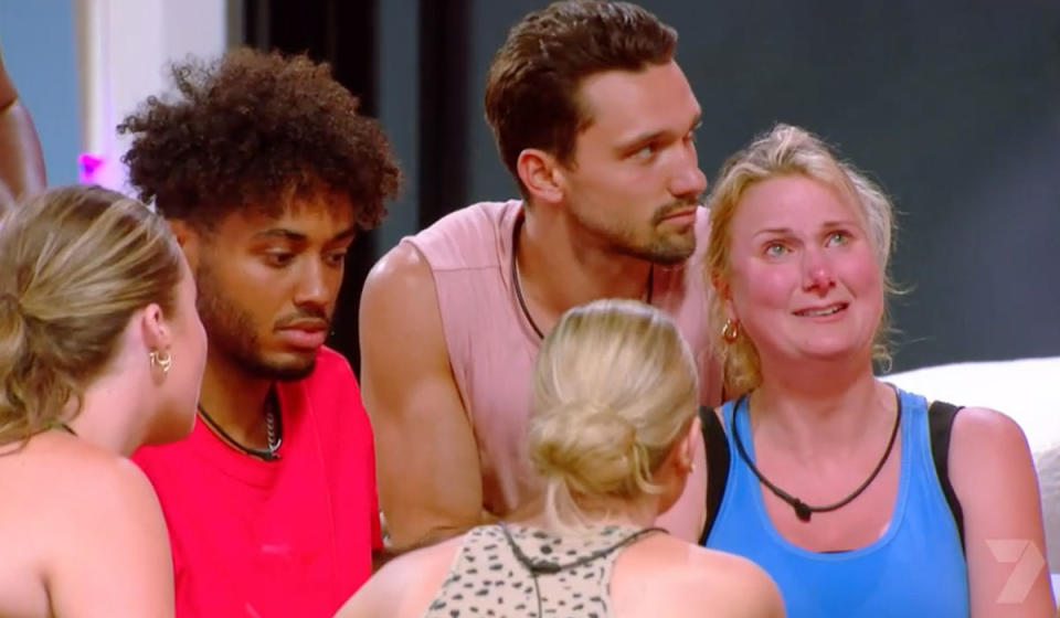 Big Brother housemate Mel is in tears with other housemates supporting her.