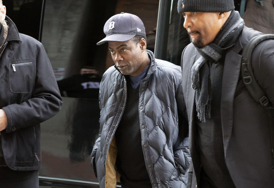 Chris Rock, center, arrives at the Wilbur Theater before a performance, Wednesday, March 30, 2022, in Boston. (AP Photo/Michael Dwyer)