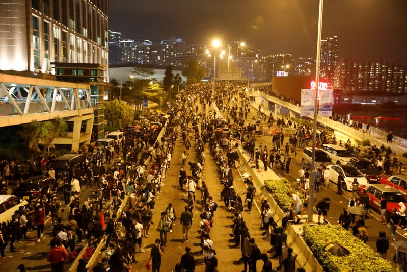 Anti-government demonstrators block a road near the Hong Kong Polytechnic University (PolyU) in Hong Kong