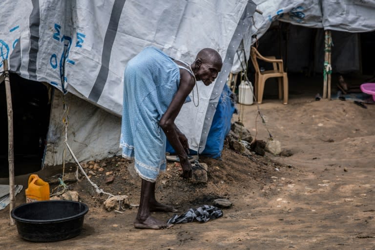 Kot Lero, who has spinal tuberculosis, cleans around her shelter. The camp houses around 7,000 people who have fled South Sudan's conflict -- 200 of them have severe disabilities