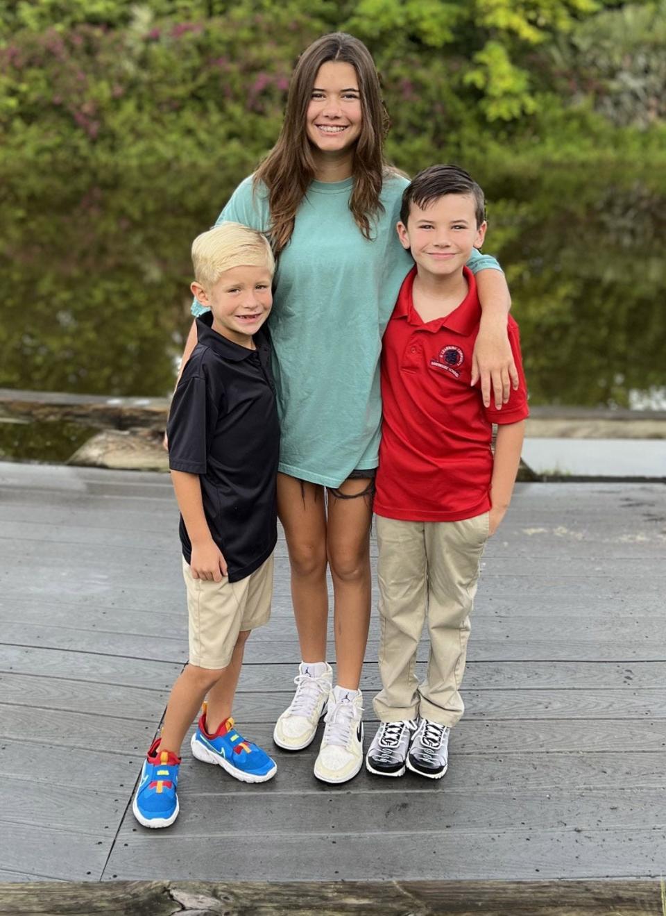 Lilly Glaubach, with her step brother Marshall Alexander, left, and brother, Peter, right. 