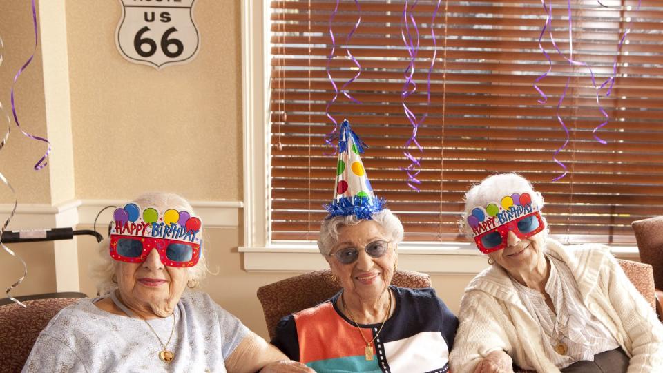 senior citizen ladies in birthday hats and party glasses