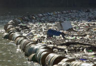 Plastic bottles, wooden planks, rusty barrels and other garbage clogging the Drina river near the eastern Bosnian town of Visegrad, Bosnia, Tuesday, Jan. 5, 2021. Further upstream, the Drina tributaries in Montenegro, Serbia and Bosnia are carrying even more waste after the swollen rivers surged over the the landfills by their banks. The Balkan nations have poor waste management and tons of garbage routinely end up in rivers. (AP Photo/Eldar Emric)