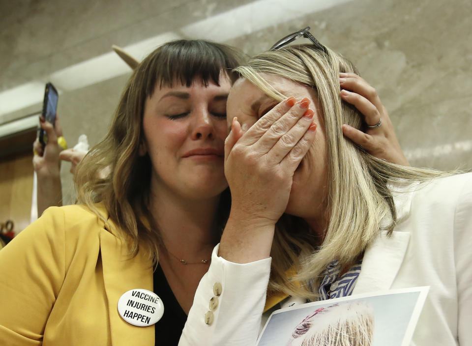 Jessica Purciful, left, and Angela Hicks, who both opposed a measure that would give public health officials oversight of doctors that may be giving fraudulent medical exemptions from vaccinations, console each other after Bill SB276 was approved by the Assembly Health Committee at the Capitol in Sacramento, Calif., Thursday, June 20, 2019. (AP Photo/Rich Pedroncelli)