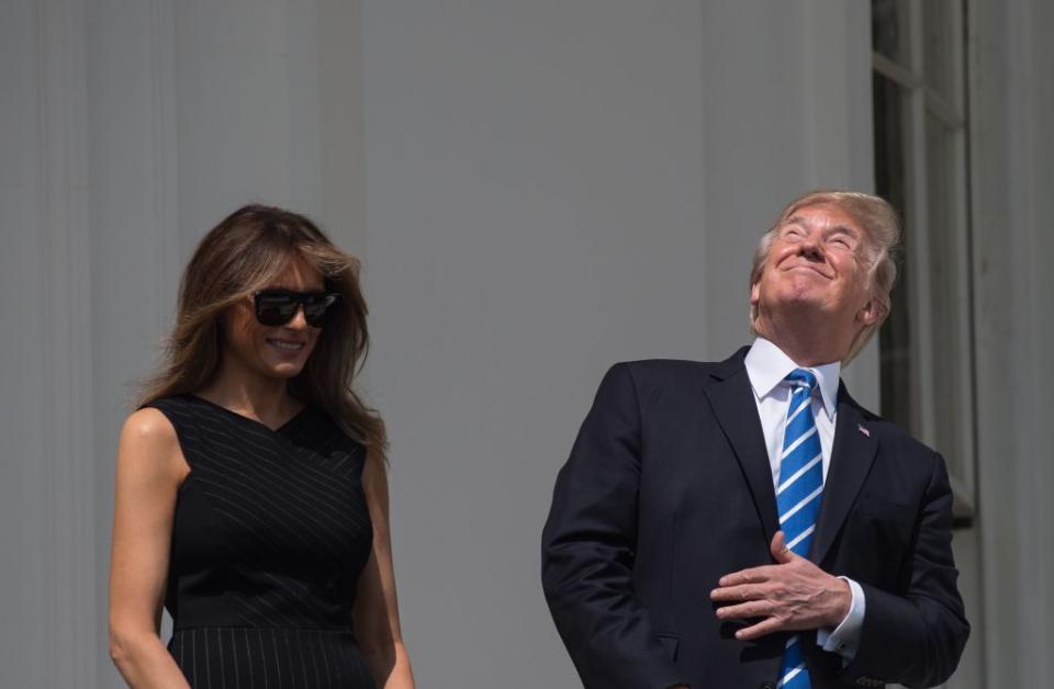 President Donald Trump and First Lady Melania Trump look up at the partial solar eclipse from the balcony of the White House in Washington, DC, on Aug. 21, 2017. / Credit: Nicholas Kamm/AFP/Getty Images