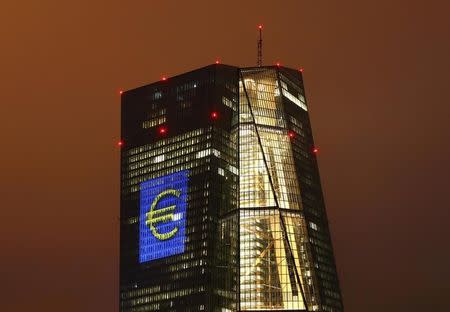 The headquarters of the European Central Bank (ECB) is illuminated with a giant euro sign at the start of the "Luminale, light and building" event in Frankfurt, Germany, March 12, 2016. REUTERS/Kai Pfaffenbach/File Photo