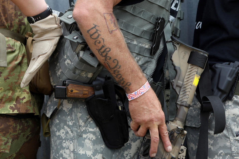 <p>A tattoo reads “We the People” as members of self-described patriot groups and militias run through close quarter combat shooting drills during III% United Patriots’ Field Training Exercise outside Fountain, Colo., July 29, 2017. (Photo: Jim Urquhart/Reuters) </p>