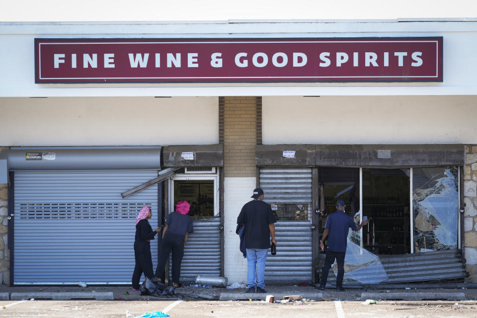 People view a ransacked liquor store in Philadelphia, Wednesday, Sept. 27, 2023. Police say groups of teenagers swarmed into stores across Philadelphia in an apparently coordinated effort, stuffed bags with merchandise and fled. (AP Photo/Matt Rourke)