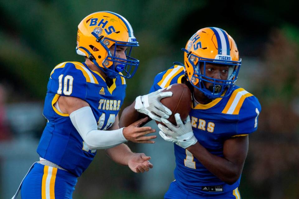 Bay High quarterback Xander Ladner hands the ball off to Jaylen Antoine during a game against St. Stanislaus at Bay High in Bay St. Louis on Friday, Sept. 1, 2023.