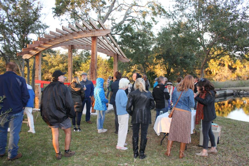 About 50 people took part in a Nov. 23 event to celebrate the conservation acquisition of the Bennett’s Landing property, named in honor of Sara Bennett and Fenis Reuben Bennett, Sr. The half-acre parcel that makes up Bennett’s Landing, and where the pergola now serves as an entryway for the neighborhood community, is also an extension to the Tide Views Preserve.