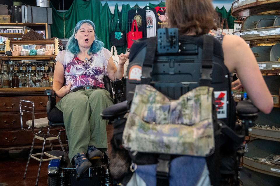 Amanda Levesque talks to her coworker, Hayley Michaels, at their workplace, Madame Clutterbuckets, August 6, 2023, in Asheville.