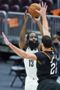 Brooklyn Nets' James Harden (13) shoots over Cleveland Cavaliers' Larry Nance Jr. (22) during the second half of an NBA basketball game, Wednesday, Jan. 20, 2021, in Cleveland. The Cavaliers won 147-135 in double-overtime. (AP Photo/Tony Dejak)